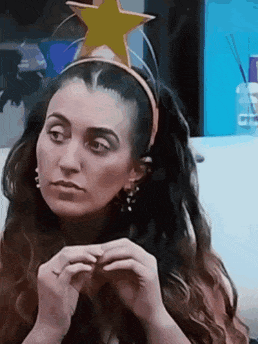 a woman wearing a headband with a star on top