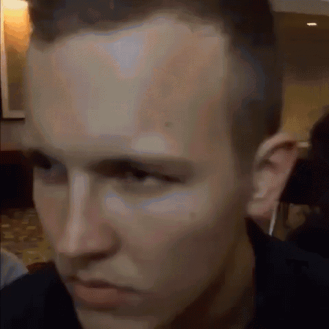a close up of a man 's face looking at the camera