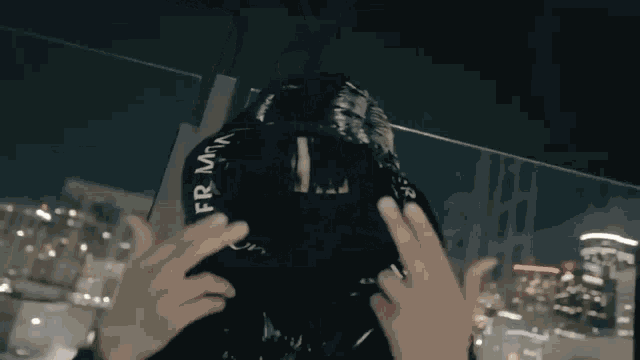 a person wearing a black jacket that says moncler on the front