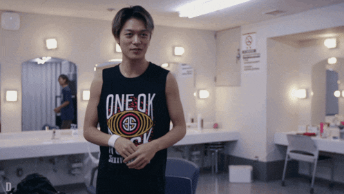 a man in a tank top that says one ok on it