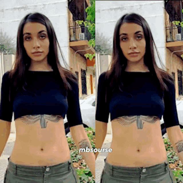a woman with a tattoo on her stomach is standing in front of a building with mbsource written on the bottom right
