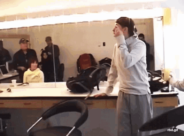 a man standing in front of a mirror with the url rbd.gif visible