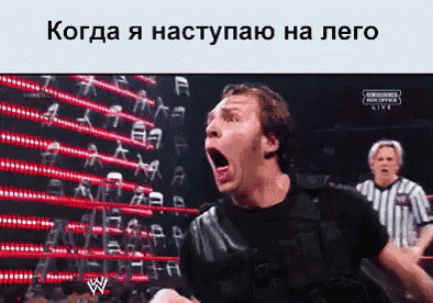a man with his mouth open is in a wrestling ring with a referee in the background