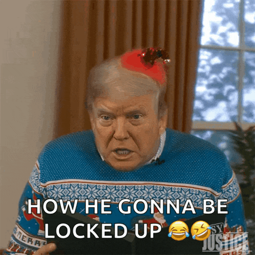 a man wearing a blue sweater and a santa hat says how he gonna be locked up