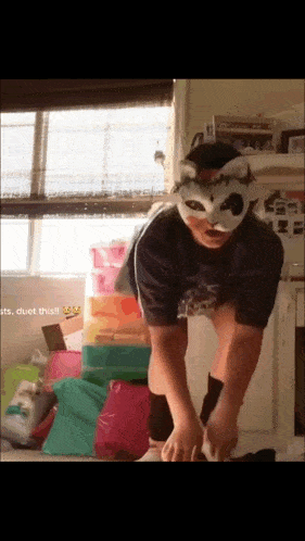 a person wearing a mask is standing in front of a pile of boxes