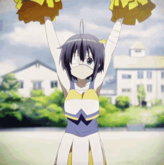 a girl in a cheerleader outfit holds up her pom poms