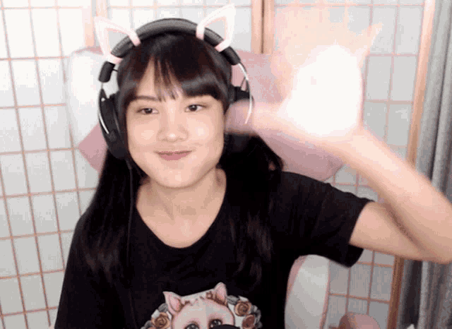 a girl wearing headphones and a cat ear headband