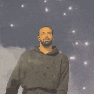 a man with a beard wearing a black hoodie with the letter b on it