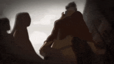 a group of people are standing next to each other in a dark room in a cartoon .