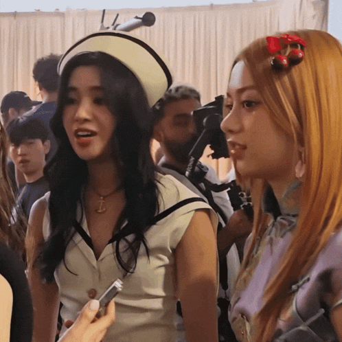a woman with a cherry in her hair is being interviewed