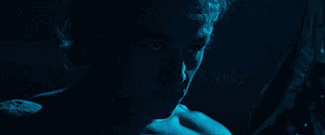 a close up of a person 's face with a blue background