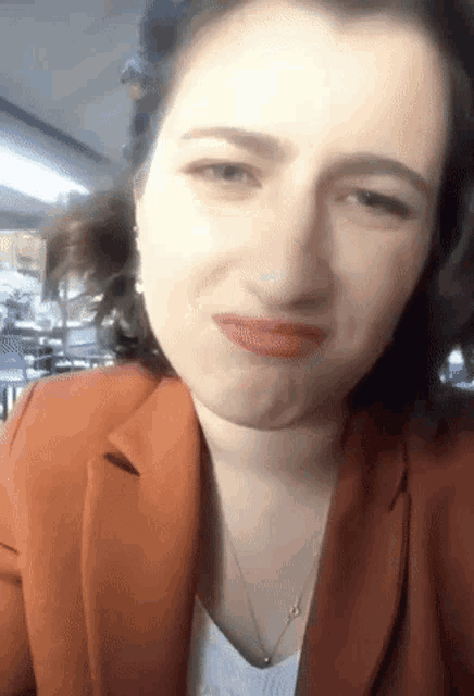 a close up of a woman making a face with her mouth open