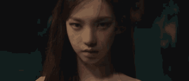 a close up of a woman 's face with a serious look on her face .