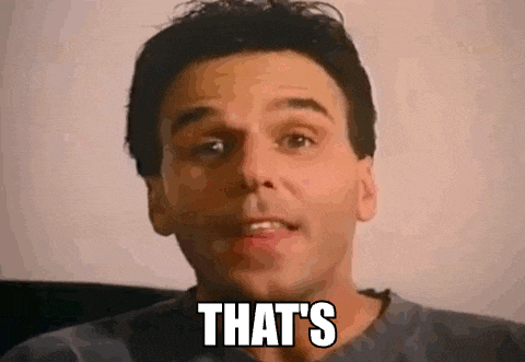 a man is sitting in a chair with the words `` that 's '' on his face .