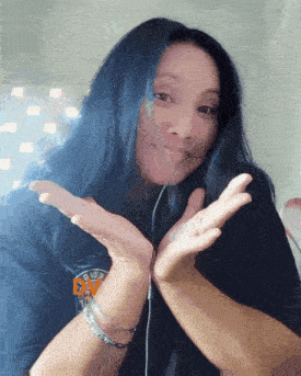 a woman with blue hair is wearing a black shirt that says " punk " on it