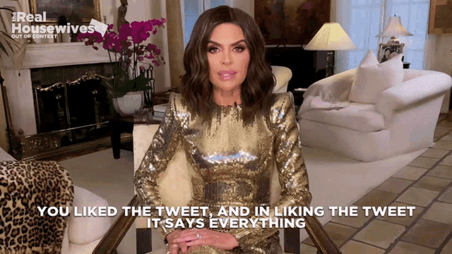 a woman in a gold dress says you liked the tweet and in liking the tweet it says everything on the screen