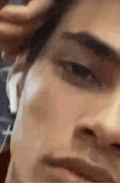 a close up of a man 's face wearing ear buds .