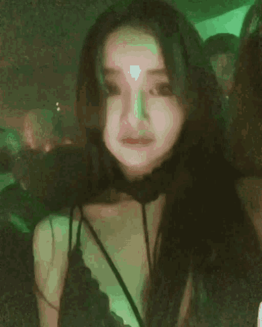 a woman with long black hair is wearing a choker .