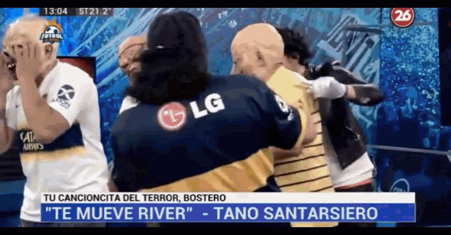a man in an lg shirt hugs another man