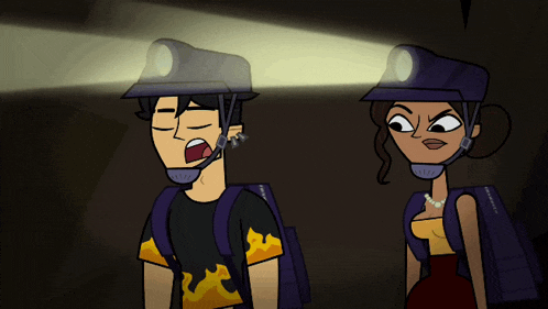 a man and a woman wearing hard hats are standing in a dark cave