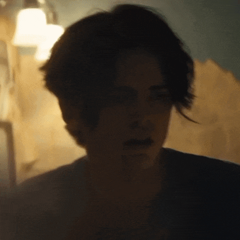 a close up of a man 's face in a dark room .