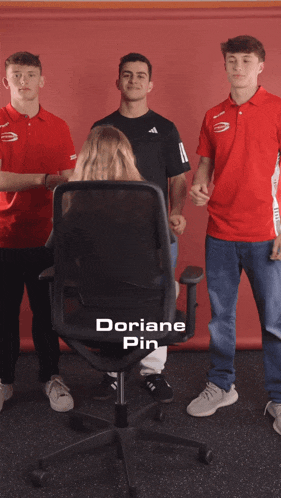 a group of young people standing around a chair with the name doriane pin on it