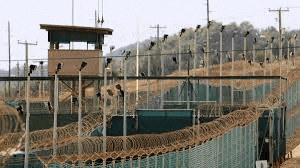 a barbed wire fence surrounds a prison .