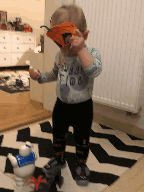 a toddler wearing a shirt that says ' time ' on the front