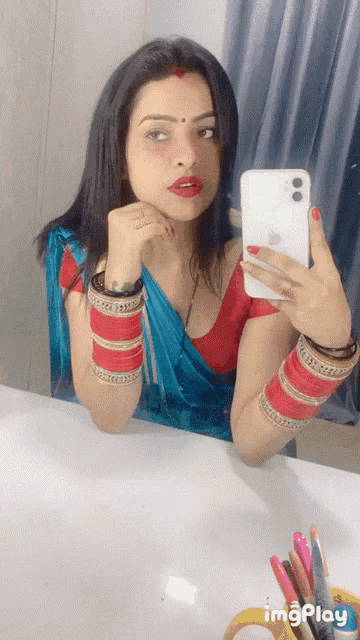 a woman is taking a picture of herself in a mirror with a white iphone