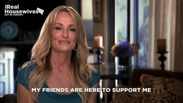 a woman says " my friends are here to support me " in front of a real housewives poster