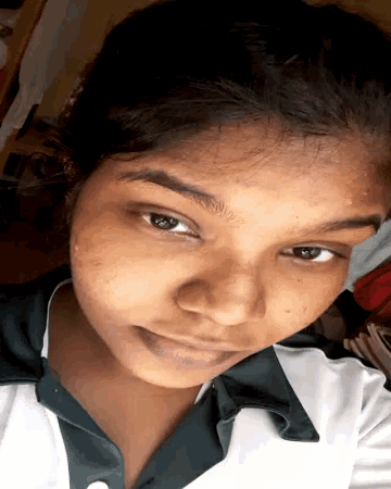 a close up of a woman 's face with a green and white shirt on