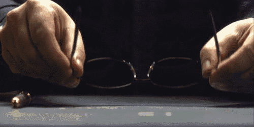a close up of a person 's hands holding glasses