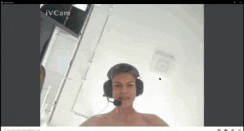 a man wearing headphones and a microphone on a video call