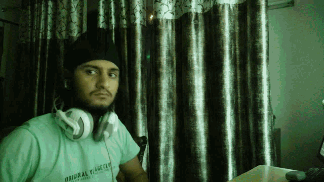 a man wearing headphones and a shirt that says " original voyage club "