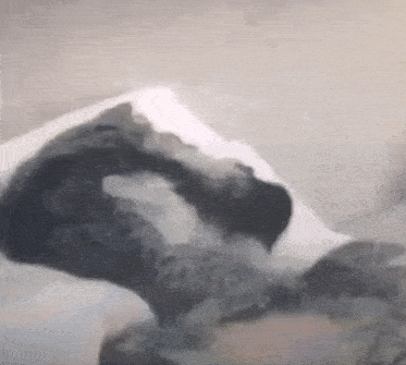 a painting of a person laying on a bed with a pillow .