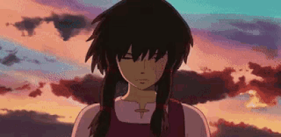 a girl in a pink dress is standing in front of a sunset .