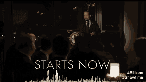 two men are sitting at a table with the words " starts now " written on it