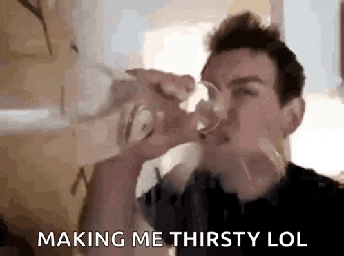 a man is drinking a glass of water with the words making me thirsty lol behind him