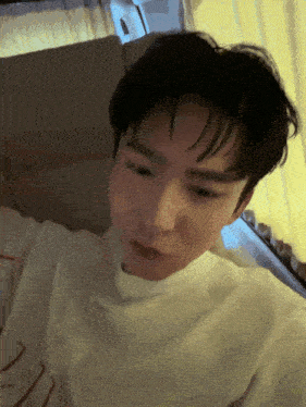 a close up of a person 's face with a white shirt that has the letter z on it