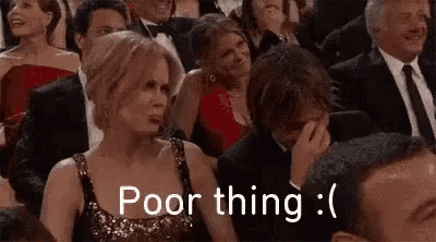 a woman in a red dress is sitting in a crowd of people with the words `` poor thing '' written on the screen .
