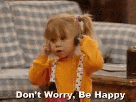 a little girl is wearing headphones and saying `` do n't worry be happy '' .