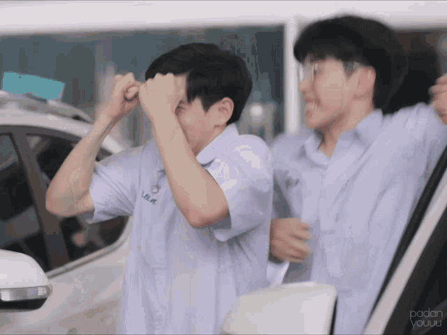two boys are standing next to each other with one wearing a shirt that says lb.r.