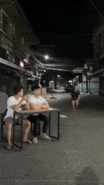 a man in a blue shirt is running down a street