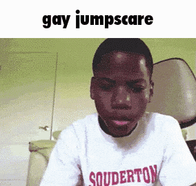 a boy wearing a shirt that says souderton looks at the camera
