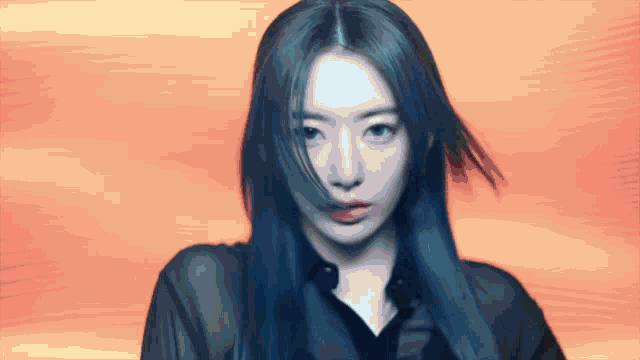 a woman with blue hair and a black shirt is looking at the camera