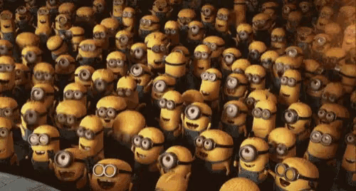 a large group of minions are gathered together in a dark room