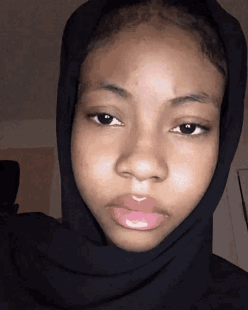 a woman wearing a black scarf around her head