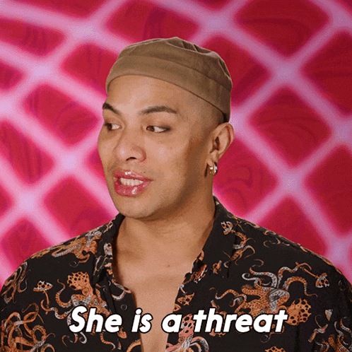 a man says she is a threat with a pink background