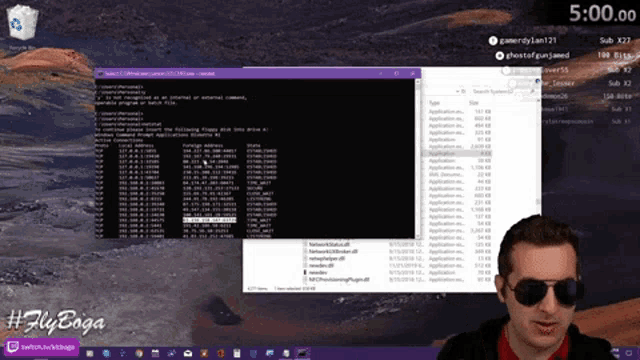 a man wearing sunglasses stands in front of a computer screen that says 5:00 on it
