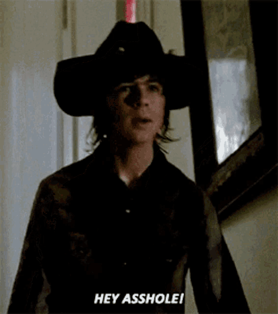 a man in a cowboy hat is saying " hey asshole "
